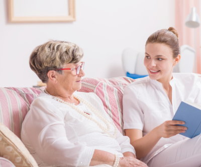 Image of carer sitting on sofa with a client